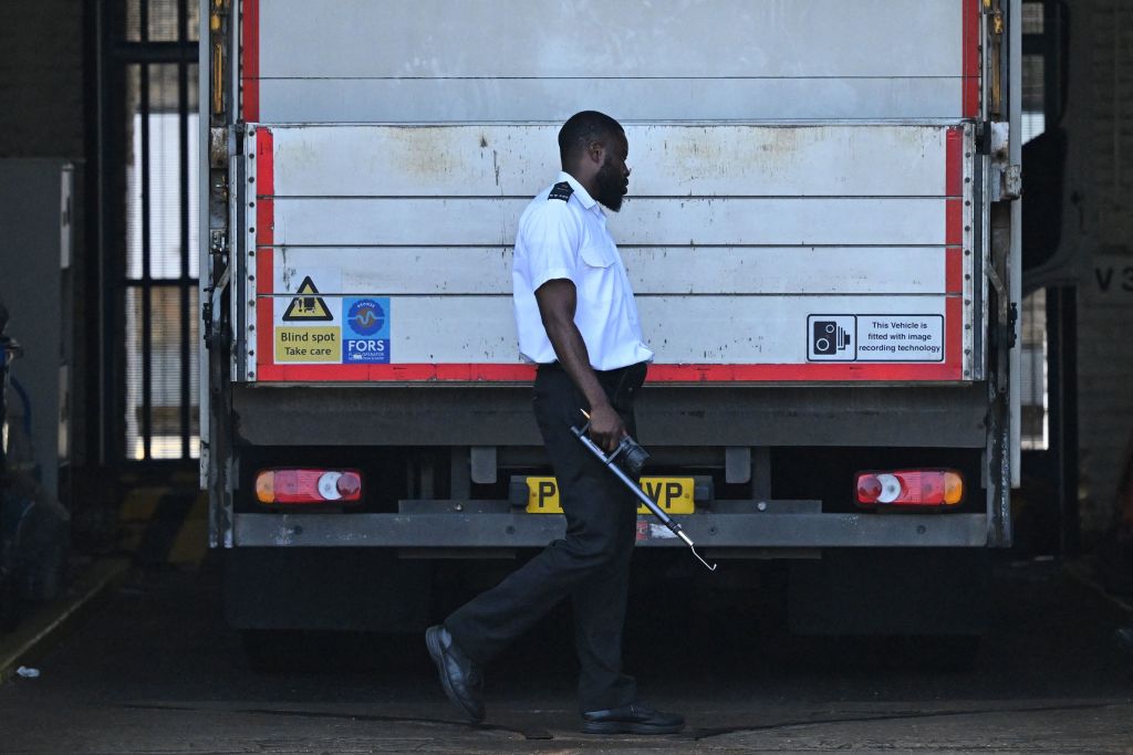 A prison guard walks around the rear of a van at the gates of HM Prison Wandsworth in south London on September 7, 2023, a day after terror suspect, Daniel Abed Khalife escaped from the prison while awaiting trial.