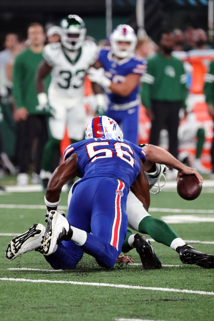 Quarterback Aaron Rodgers of the New York Jets is sacked by Leonard Floyd #56 of the Buffalo Bills and suffers an Achilles injury in the game at MetLife Stadium on September 11, 2023 in East Rutherford, New Jersey.