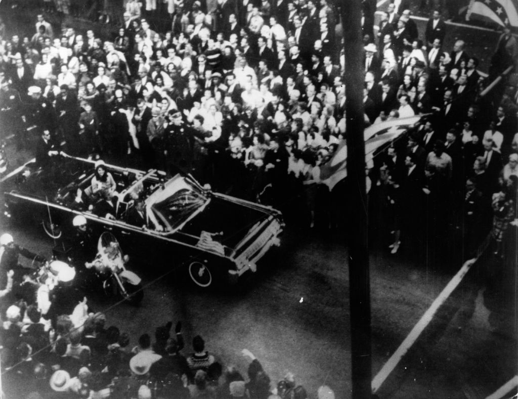 John F. Kennedy, 35th president of the U.S., and First Lady Jacqueline Kennedy traveling in the presidential motorcade at Dallas, shortly before his assassination.