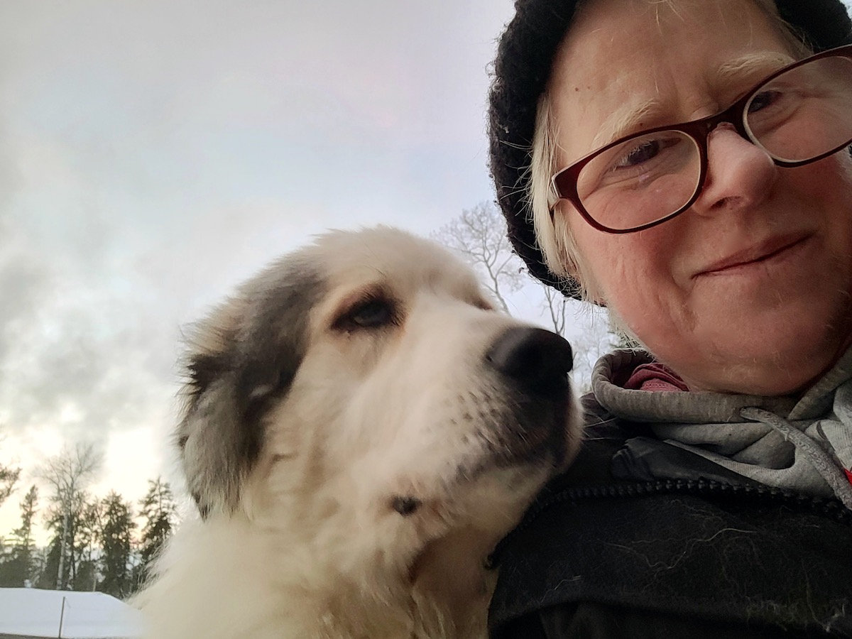 A woman poses for a selfie with her dog
