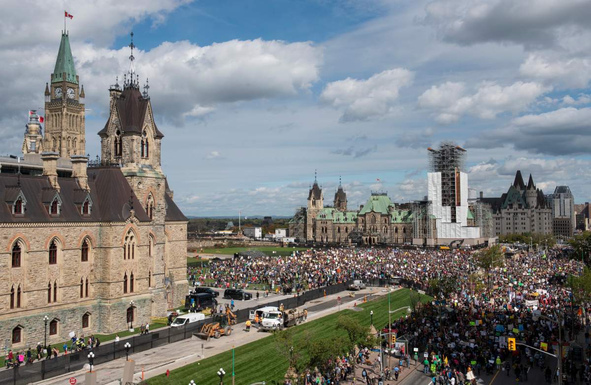 People gather on Parliament Hill in Ottawa as part of a Global Climate Strike, protesting against climate change and inaction