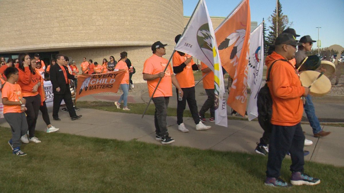 Hundreds of people walked in support for residential school survivors and the children who did not make it home at a community smudge walk at the First Nations University.