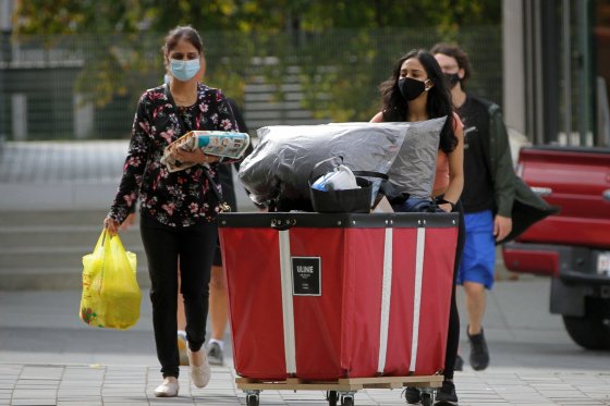 A student and her family member move belongings to her residence around the campus of University of British Columbia