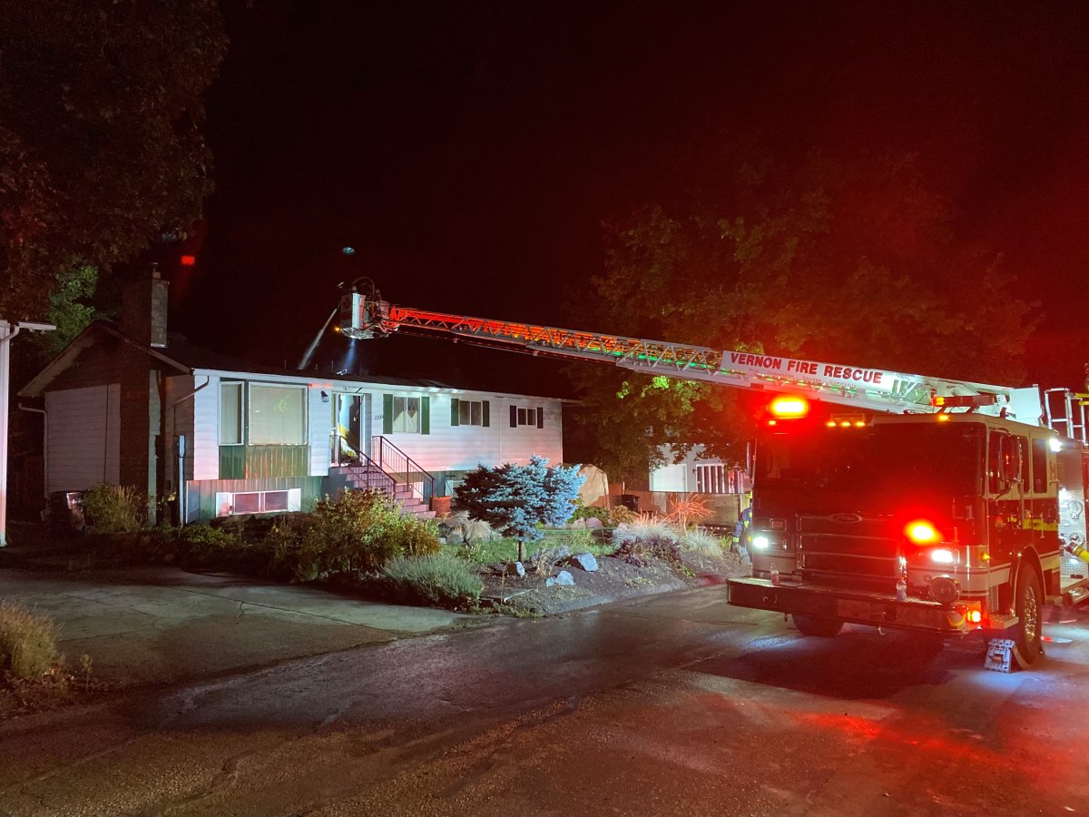 A ladder truck helps extinguish an overnight fire in Vernon’s East Hill area.