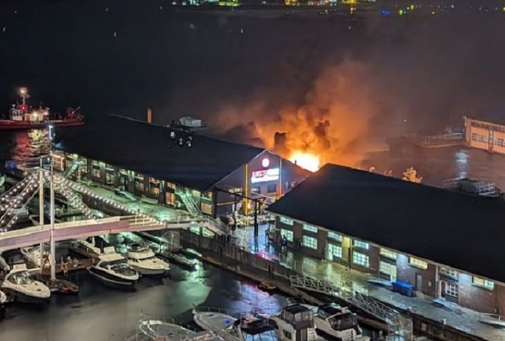 A fire breaks out at a dumpster at Amsterdam Brewhouse in Toronto on Sept. 28, 2023.