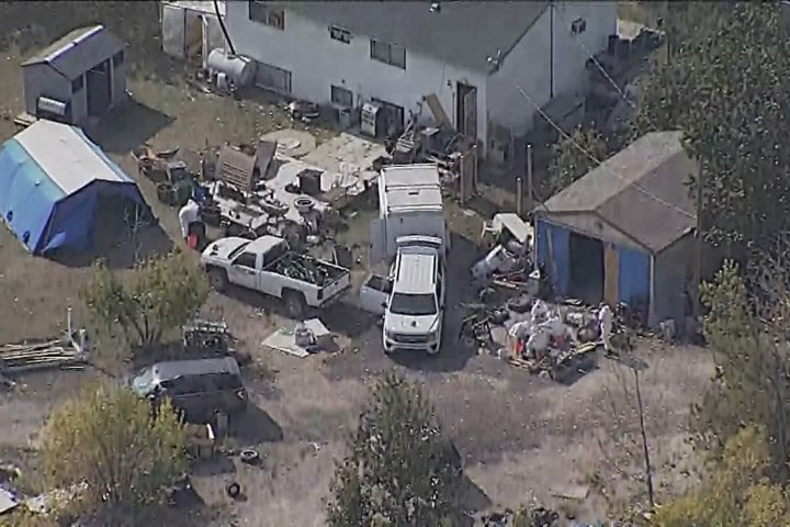 Calgary police members in hazmat suits searching property north of city