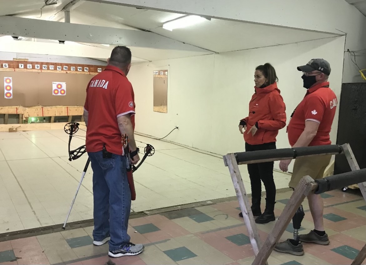 Ling and Nadin preparing for his involvement in the archery event.