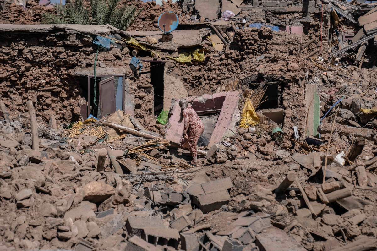A woman attempts to search the rubble of her home after the Morocco earthquake