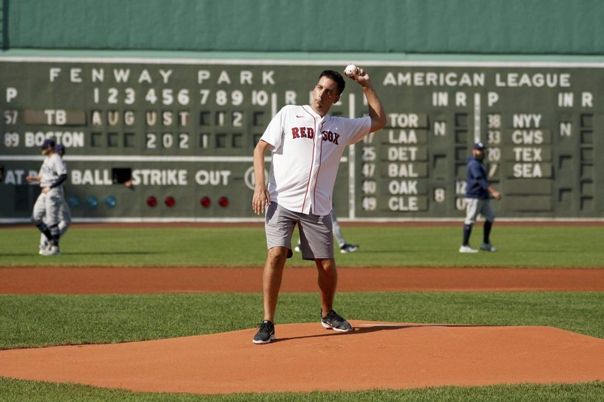 Chris Snow, an assistant general manager for the Calgary Flames, throws out a ceremonial first pitch before the baseball game between the Boston Red Sox and Tampa Bay Rays at Fenway Park in Boston on Aug. 12, 2021.