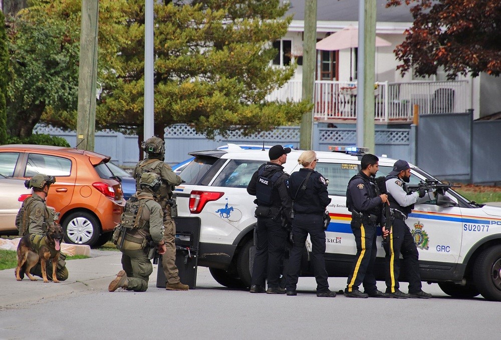 Heavily armed officers seen outside a home on Surrey's Oriole Drive on Wednesday, Sept. 27, 2023. 