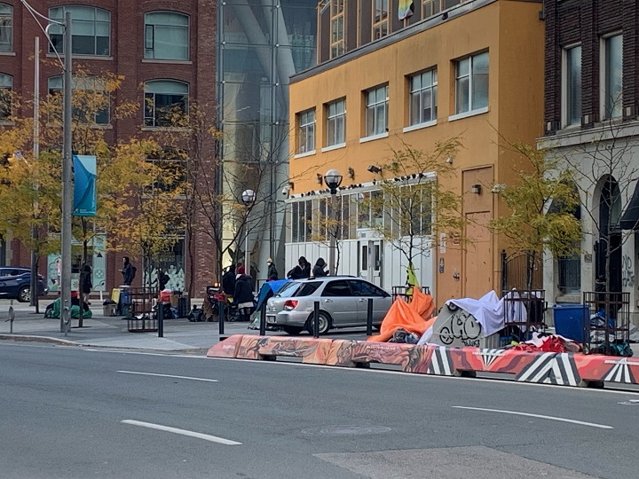 People seen outside 129 Peter Street in Toronto, October 31, 2023.