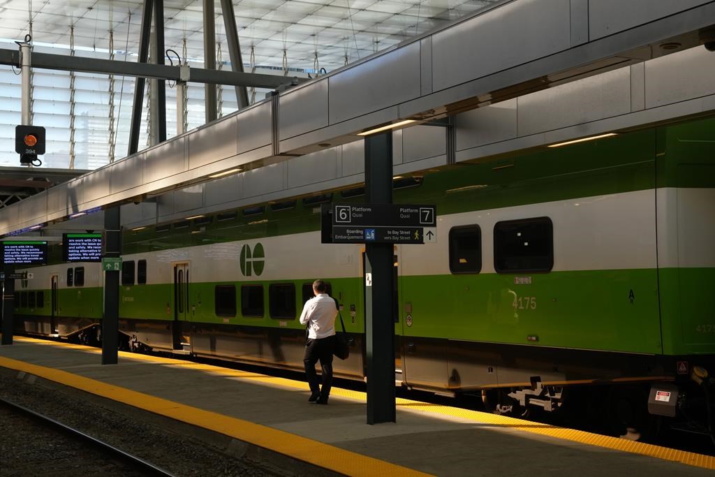 A man walks along an empty platform as a train stands idle at Toronto's Union Station after GO Transit and UP Express announced that trains are not running on the entire network due to a networkwide system failure on Tuesday.