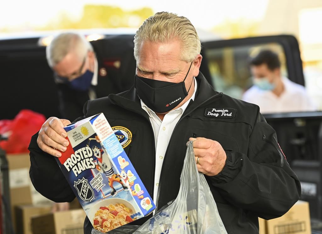Ontario Premier Doug Ford delivers food at the Salvation Army food bank during the COVID-19 pandemic in Toronto on Friday, October 9, 2020. Ontario is adding $5 million in funding to the Student Nutrition Program, which provides free snacks and meals to kids in schools. .