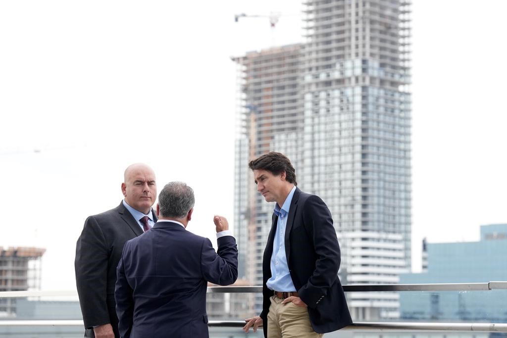 Prime Minister Justin Trudeau says the federal government has reached an agreement with Vaughan, Ont., to fast-track the building of more than 1,700 new housing units. New construction is seen behind Prime Minister Justin Trudeau during a housing announcement, in Vaughan, Ont., Thursday, Oct. 5, 2023. Vaughan mayor Steven Del Duca, left, and Vaughan-Woodbridge MP Frank Sorbara, look on.