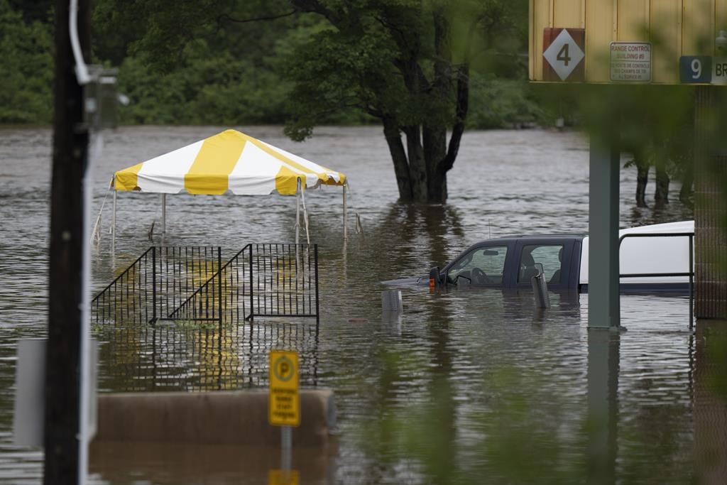 A truck is seen abandoned in floodwater following a major rain event in Halifax on July 22, 2023. THE CANADIAN PRESS/Darren Calabrese.