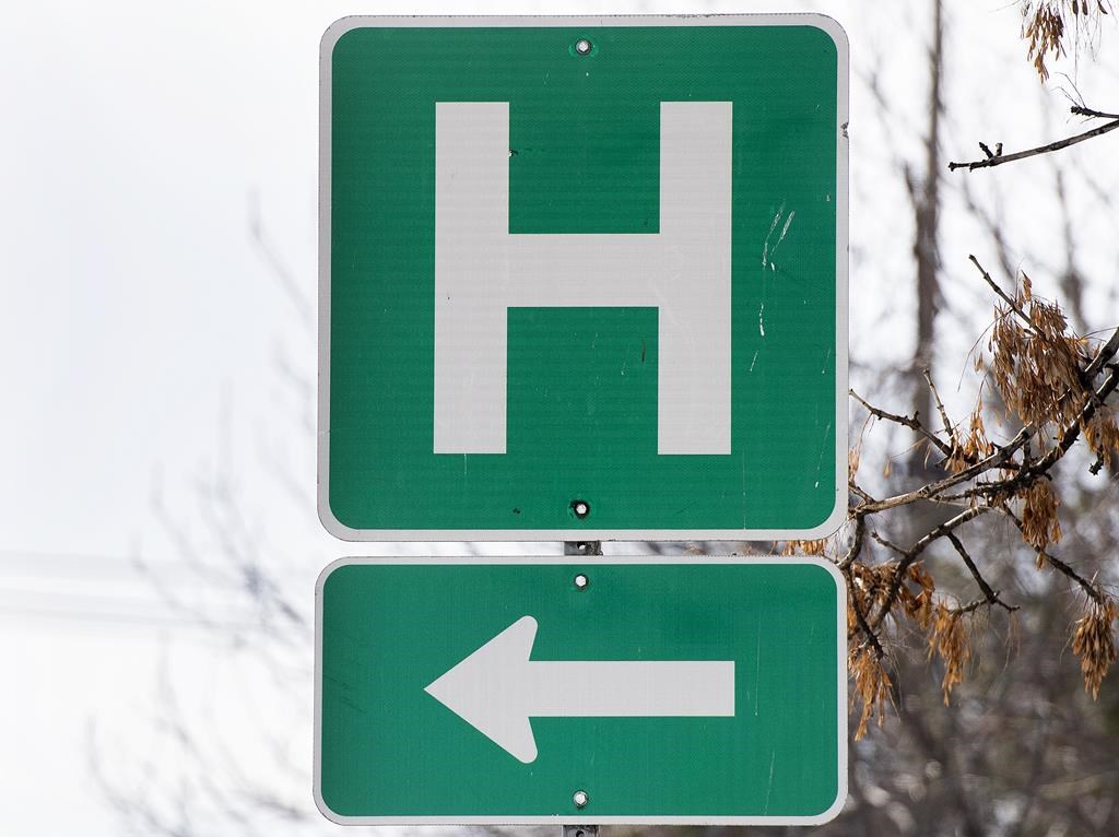 A hospital network in central Ontario says it is seeing patient volumes surge to as high as 150 per cent of their capacity. A sign for a hospital in Montreal, Sunday, Feb. 6, 2022. 