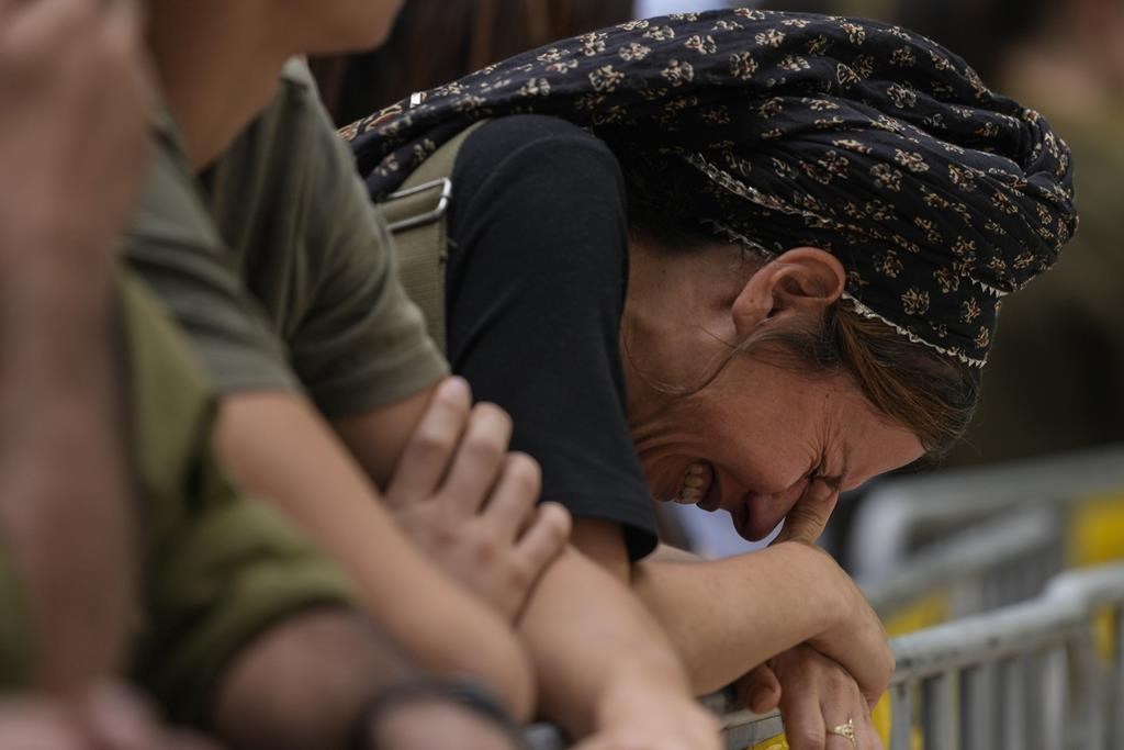 A woman cries during the funeral of Israeli Col. Roi Levy at the Mount Herzl cemetery in Jerusalem on Monday. Col. Roi Levy was killed after Hamas militants stormed from the blockaded Gaza Strip into nearby Israeli towns.