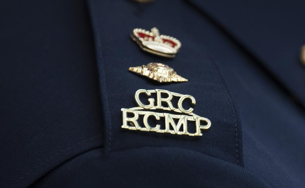 An RCMP logo is seen on the shoulder of an officer.