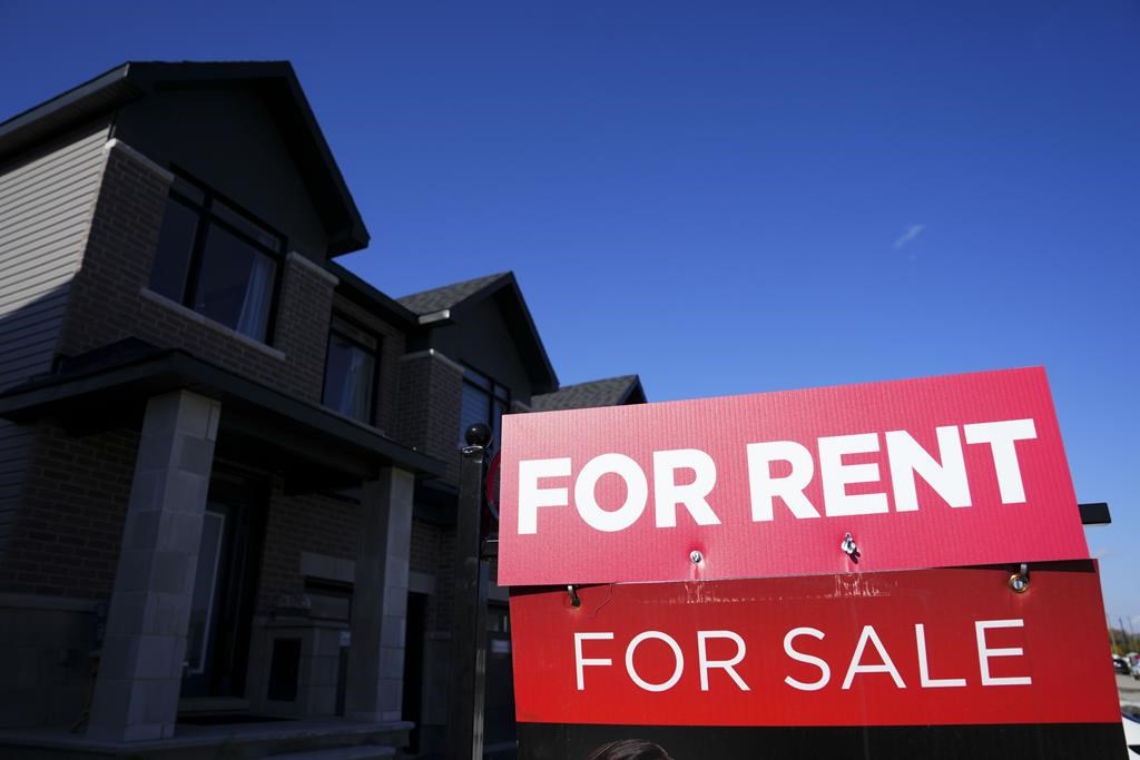 A for rent and a for sale sign are displayed on a house in a new housing development in Ottawa on Friday, Oct. 14, 2022. A new report by Rentals.ca and Urbanation says the average asking price for a rental unit in Canada reached a new high of $2,149 last month, marking an 11.1 per cent jump from the same period a year ago. 