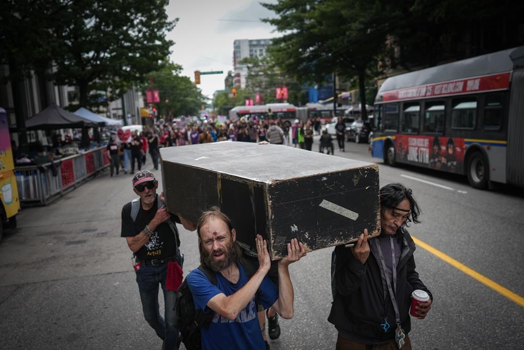 A new study says people experiencing homelessness make up a growing proportion of opioid overdose deaths in Ontario. Andrew Leavens, front left, and Carl Gladue, right, carry an empty coffin during a march organized by the Vancouver Area Network of Drug Users (VANDU) to mark International Overdose Awareness Day, in Vancouver, B.C., Thursday, Aug. 31, 2023. THE CANADIAN PRESS/Darryl Dyck.