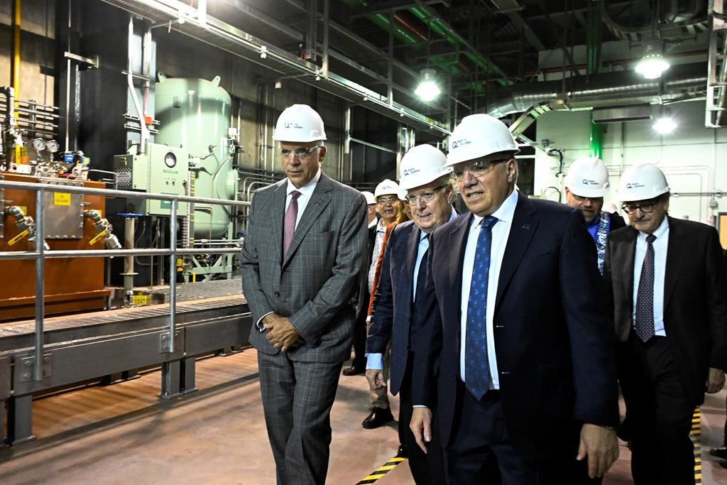 Quebec Economy and Innovation Minister Pierre Fitzgibbon, (left to right), former Quebec premier Jean Charest, Quebec Premier Francois Legault and Hydro Quebec president Michael Sabia visit the La Romaine hydroelectric plant, Thursday, October 12, 2023, in Havre Saint-Pierre, Que. Jean Charest's son is responding after Quebec Premier François Legault suggested it's an insult to be compared to the former federalist premier. THE CANADIAN PRESS/Jacques Boissinot.