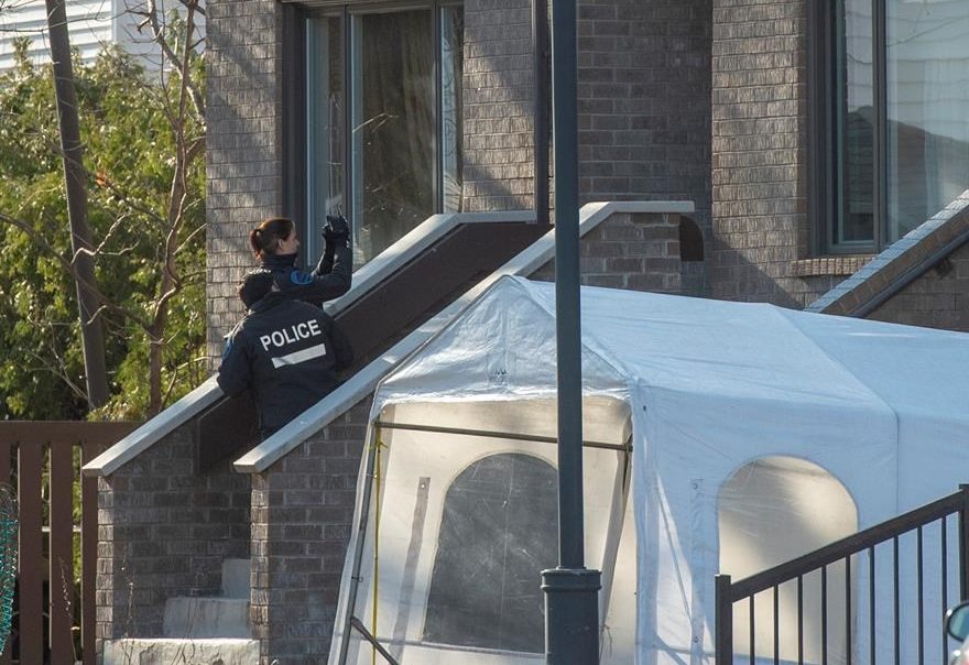 Police investigate the scene where a woman and two children were found dead in a home, Wednesday, December 11, 2019 in Montreal.THE CANADIAN PRESS/Ryan Remiorz.