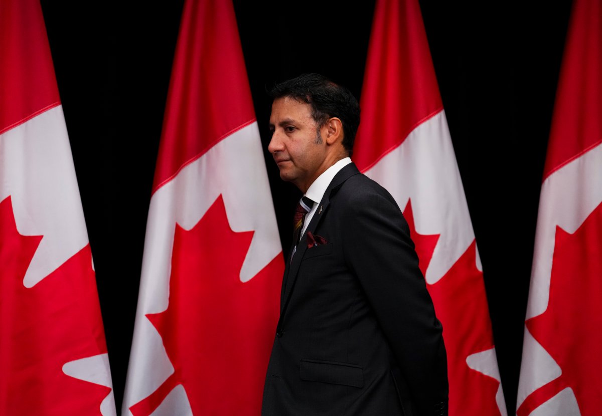 Justice Minister and Attorney General of Canada Arif Virani is shown in front of Canadian flags