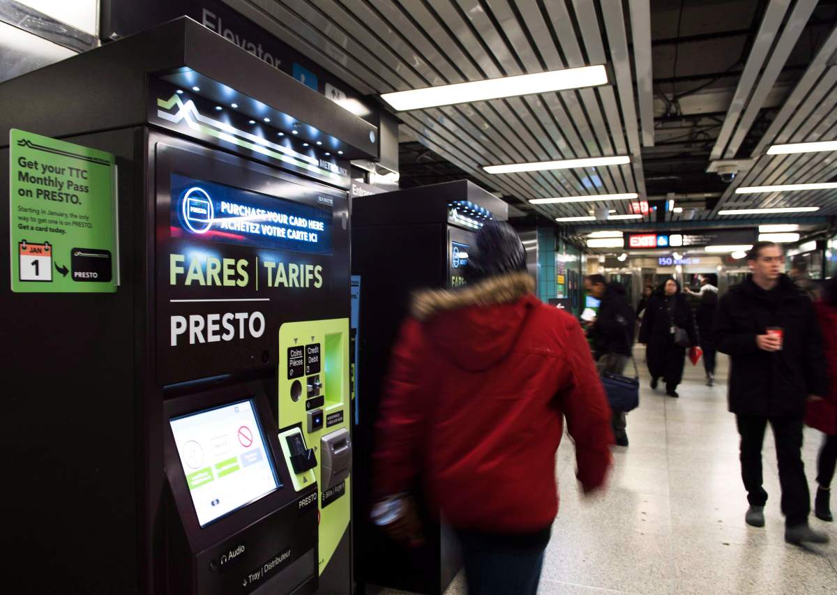 People walk past Presto machines underground in the TTC subway portals in Toronto.