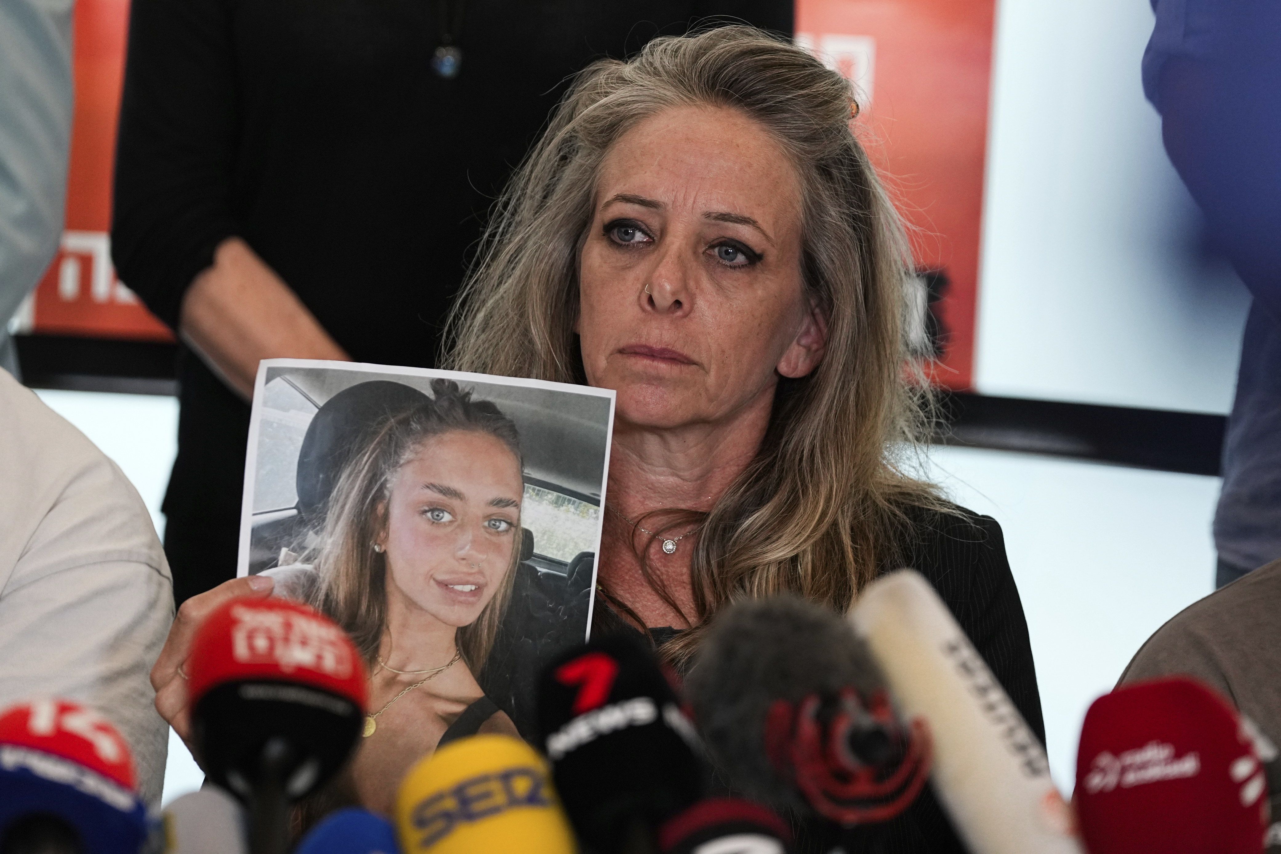 Mother of Mia Schem holds a photo of her daughter, abducted by Hamas during the Oct. 7 attack on Israel, in Tel Aviv, Israel, on Tuesday. (AP Photo/Ohad Zwigenberg)