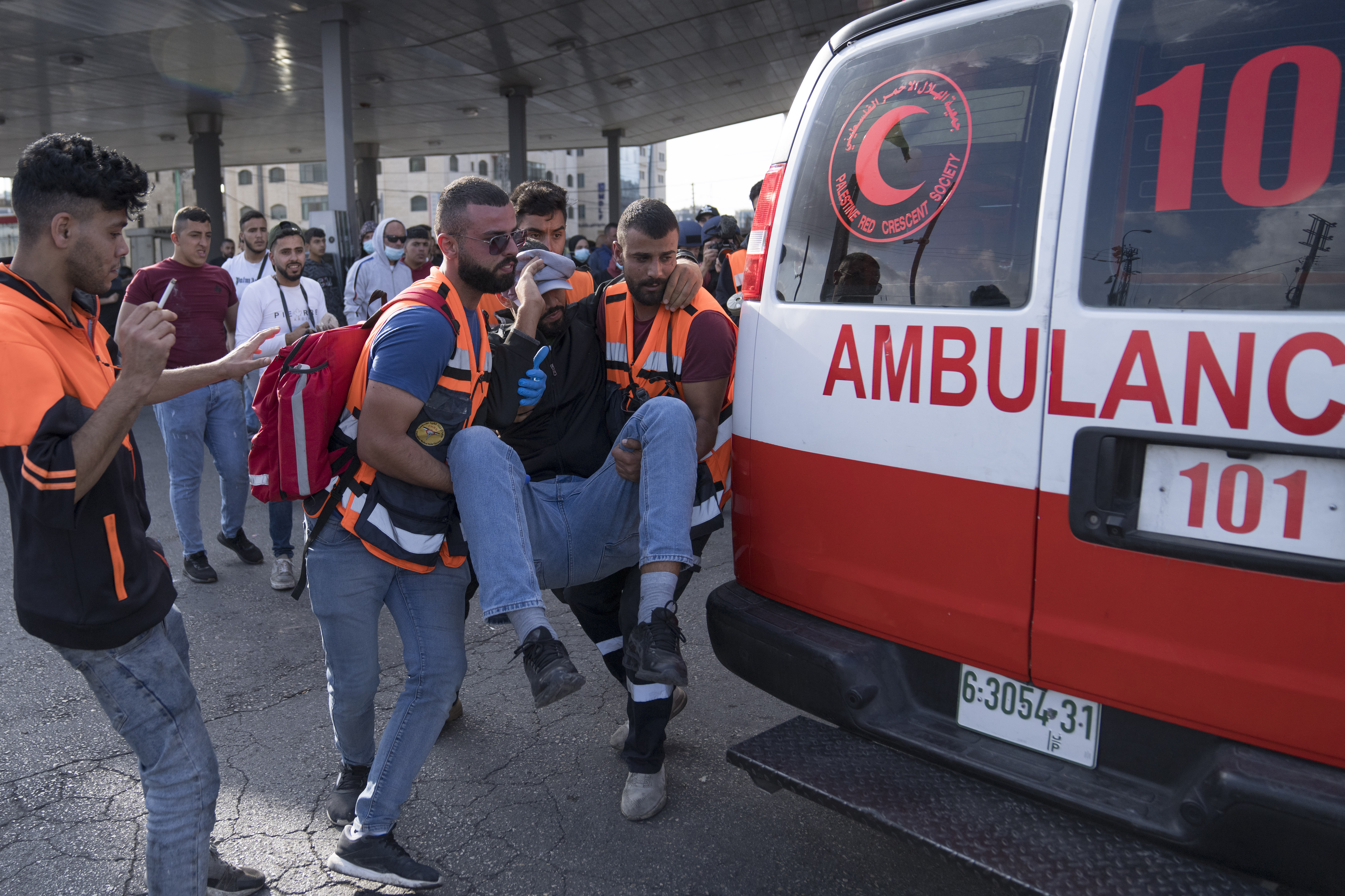 Paramedics evacuate an injured protester during clashes with the Israeli border police following a demonstration in solidarity with the Gaza Strip, in the West Bank city of Ramallah, Friday, Oct. 20, 2023. (AP Photo/Nasser Nasser)