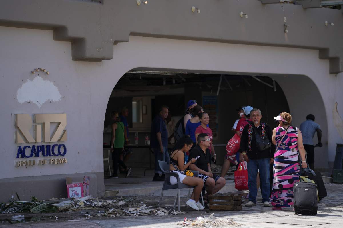 Tourists wait outside a hotel after Hurricane Otis ripped through Acapulco, Mexico on Thursday.