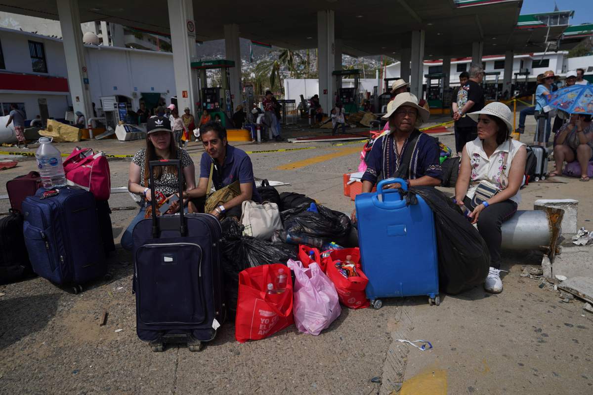 Tourists wait for transportation back to Mexico City after Hurricane Otis ripped through Acapulco, Mexico, on Thursday.