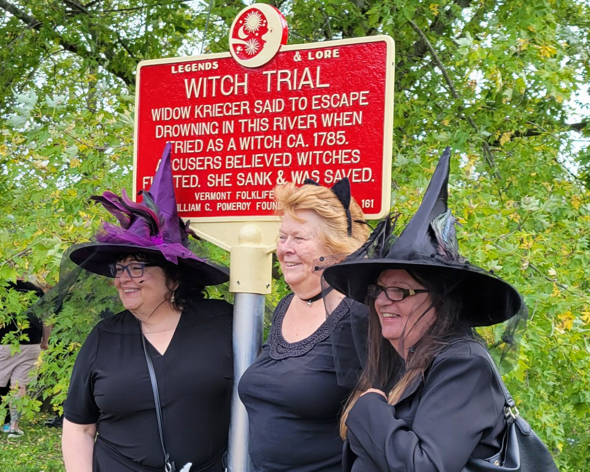In this Sept. 16, 2023 photo, provided by Alexina Jones, people dressed as witches gather near a newly installed marker, in Pownal, Vt., that recognizes the survivor of Vermont's only recorded witch trial.