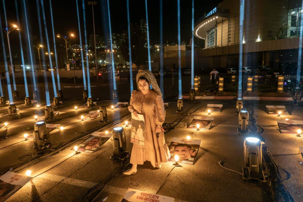 October 26, 2023, Jerusalem, Israel: A woman walks through an installation titled Lights of Hope which projects 224 beams of light for 224 seconds every hour in solidarity with the hostages in the hands of Hamas of the Gaza Strip and their families. (Credit Image: © Nir Alon/ZUMA Press Wire)