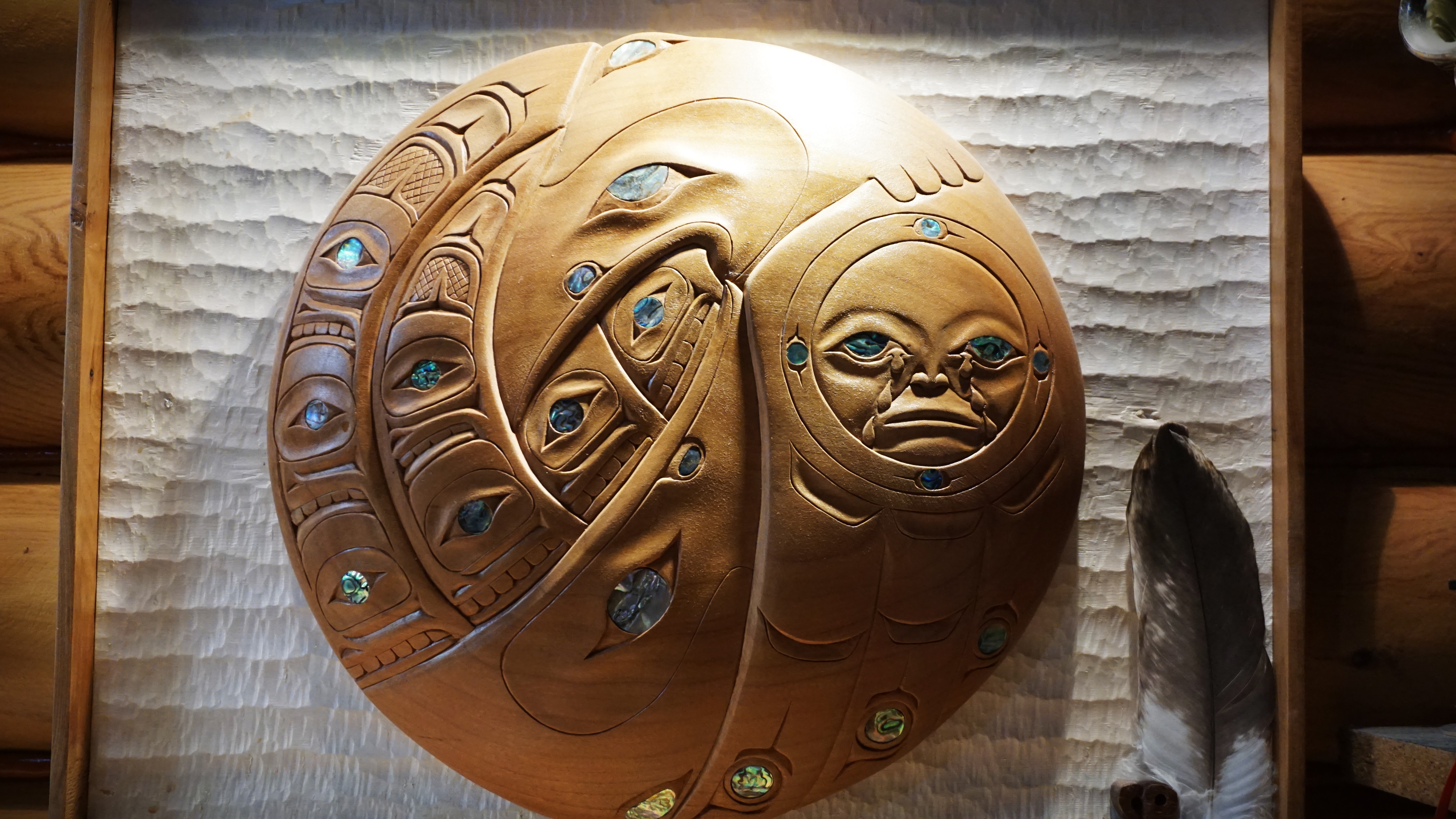 A yew wood carving inlaid with abalone shell hands on the wall of Sammy Robinson's carving shop in Kitimaat Village. The piece took years to make and Robinson describes it as "priceless."