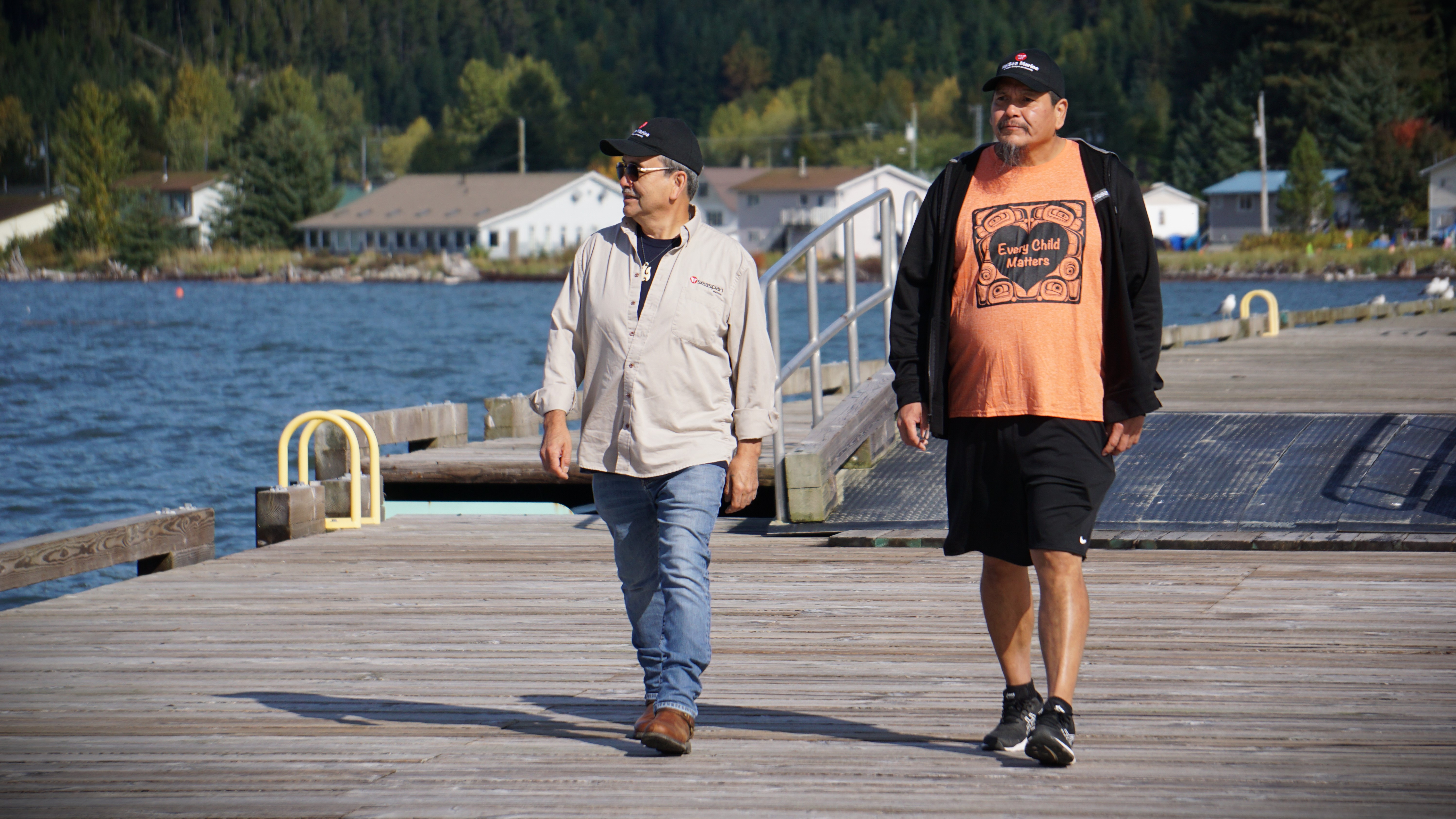 HaiSea Marine deckhands Ed Ross (left) and Darcy Woods walk on the docks of Kitimaat Village, B.C. on Thurs. Sept. 28, 2023.