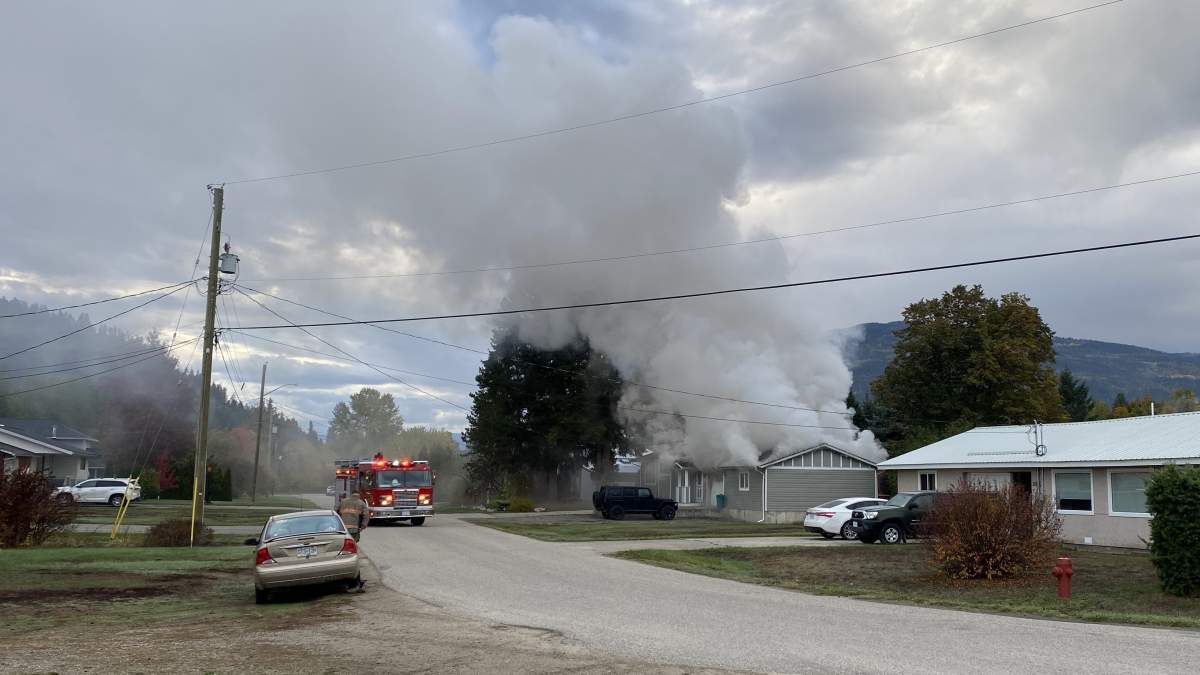 Smoke rises from a house fire in Enderby, B.C., on Saturday, Oct. 14, 2023.