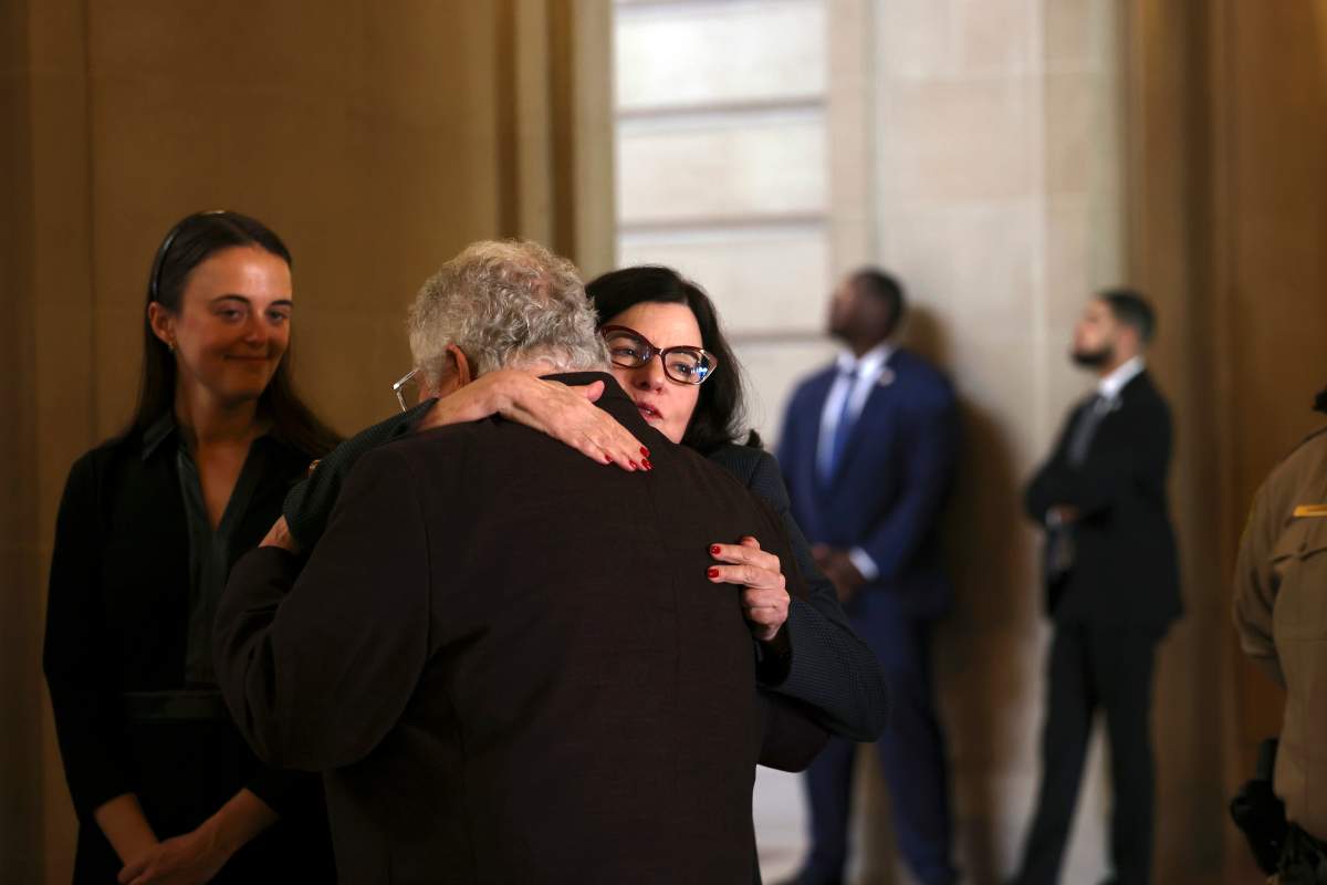 U.S. Sen. Dianne Feinstein’s granddaughter Eileen Marino, left, and daughter Katherine Feinstein share a moment at San Francisco City Hall before a public viewing in San Francisco, on Wednesday, Oct. 4, 2023. Feinstein, who died Sept. 29, served as San Francisco’s mayor.