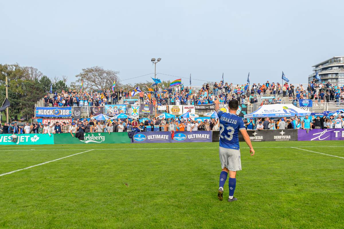 Halifax defender Riley Ferrazzo salutes a group of supporters in “The Kitchen” section of Wanderers Grounds. (Trevor MacMillan/HFX Wanderers FC)