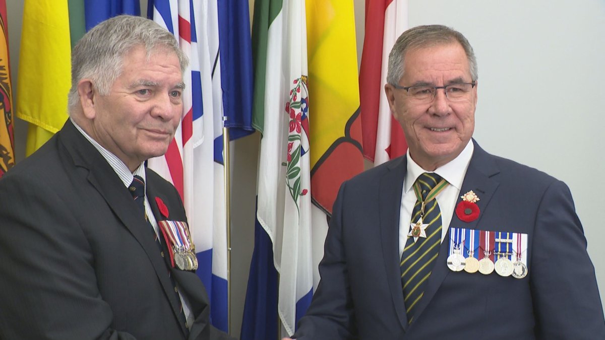 Saskatchewan Lt.-Gov. Russ Mirasty presented the third poppy to retired brigadier-general Cliff Walker, which came as a surprise to Walker.