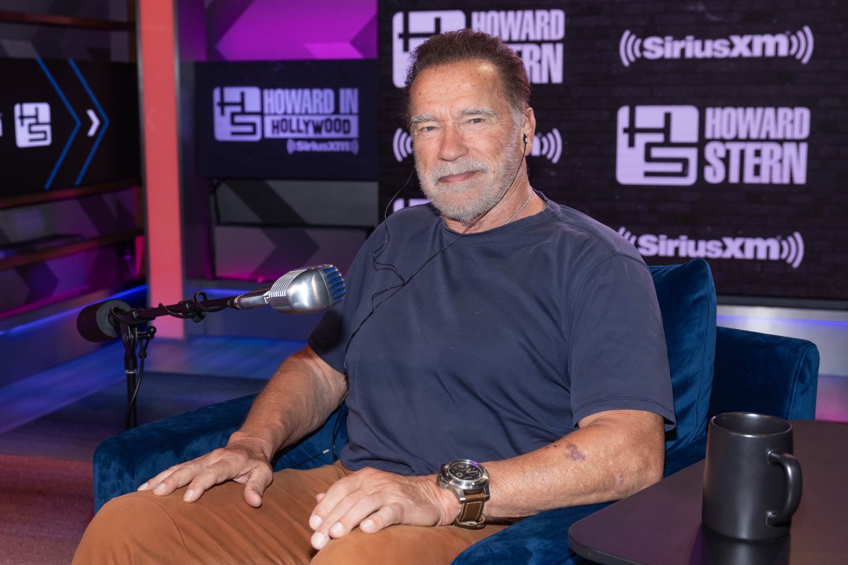 Arnold Schwarzenegger sitting in a chair.