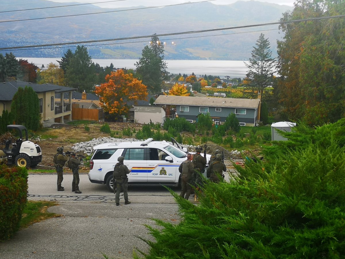 Police surround a port-a-potty in West Kelowna, B.C., on Wednesday, Oct. 18, 2023.