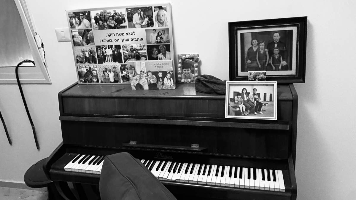 A pre-Holocaust family portrait on top of Moshe Ridler's piano after Hamas attacked his home in Holit, Israel.