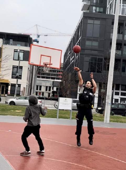 Mustafa Popalzai plays basketball with youth in Regent Park