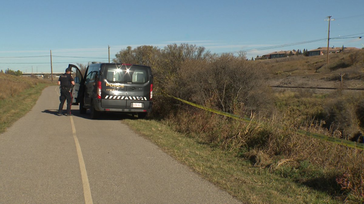A CPS unit and police tape along the Nose Creek Pathway on Oct. 19 during the investigation into a suspected domestic assault earlier this week. A victim was located in life-threatening condition.