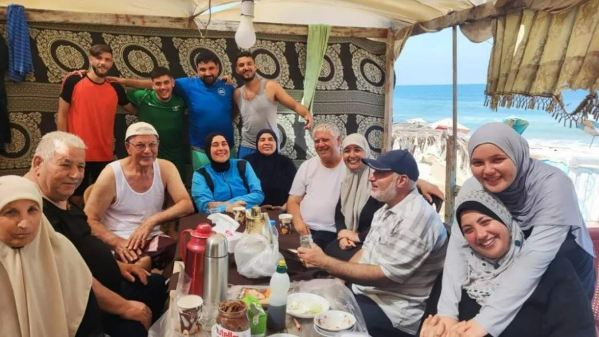 London, Ont., resident Reem Sultan, seated in the centre wearing a blue jacket, is seen with her family at a beach in Gaza in an undated handout photo prior to the outbreak of the conflict between Hamas and Israel.