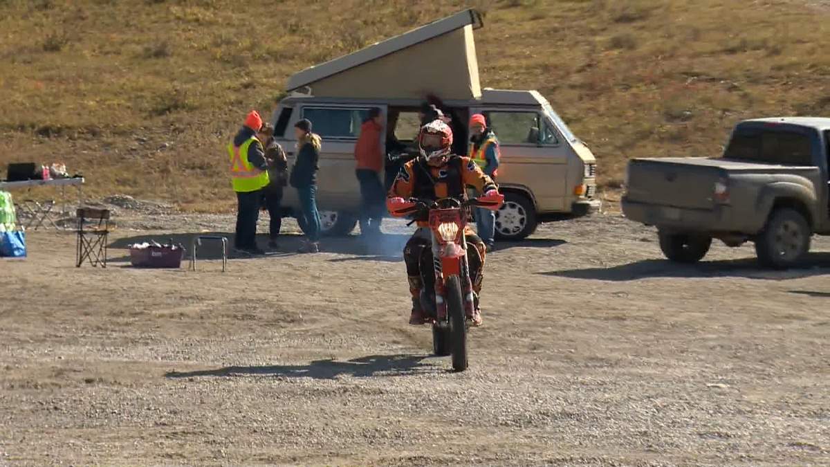 A rider on a dirt bike starts on a search for Amy Fahlman west of Calgary on Oct. 5, 2023.