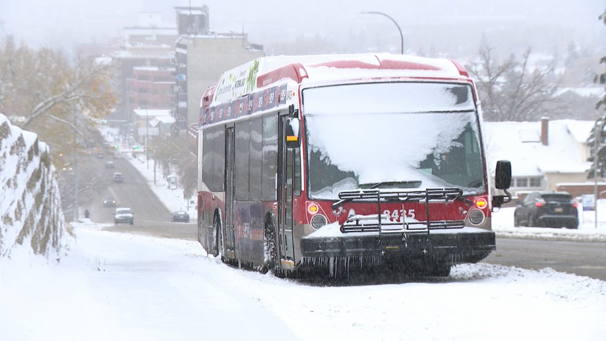 A Calgary Transit bus is abandoned after being unable to get up 14th Street Northwest on Oct. 24, 2023.