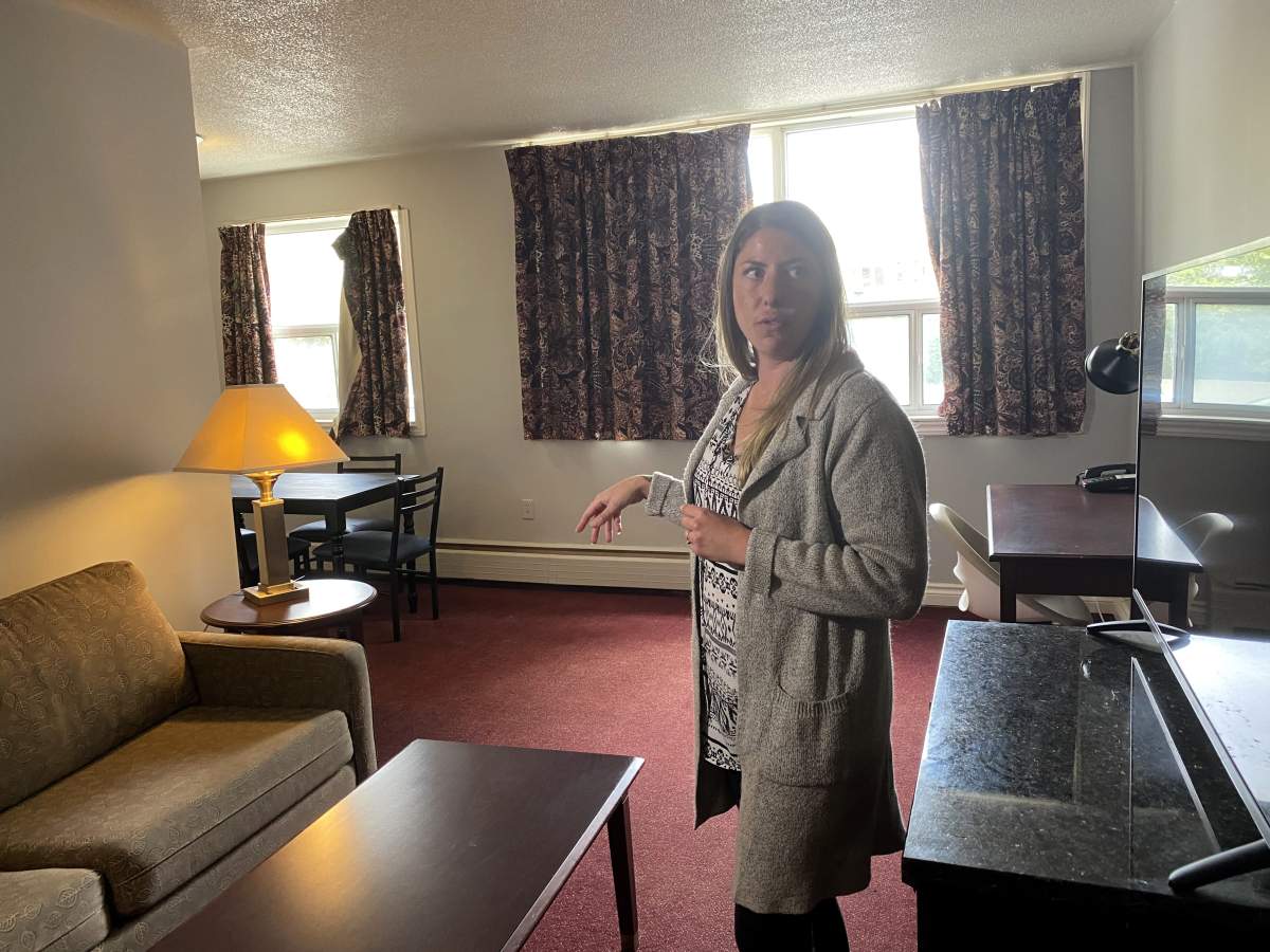 Chantelle McDonald, the service director at London Cares, tours the living room of one of the two bedroom units.