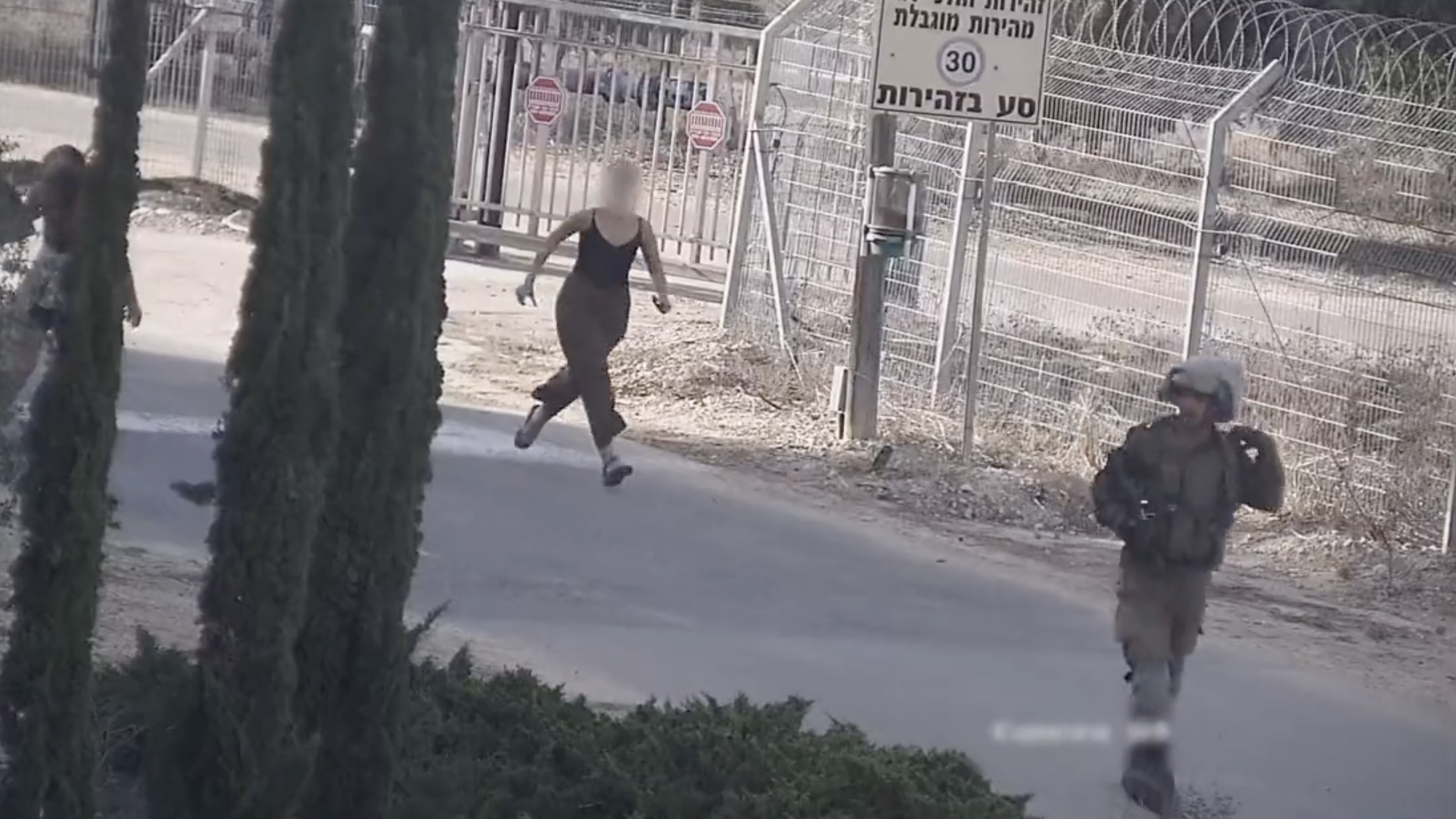 An Israeli soldier evacuates residents of Be’eri on Oct. 7, 2023.